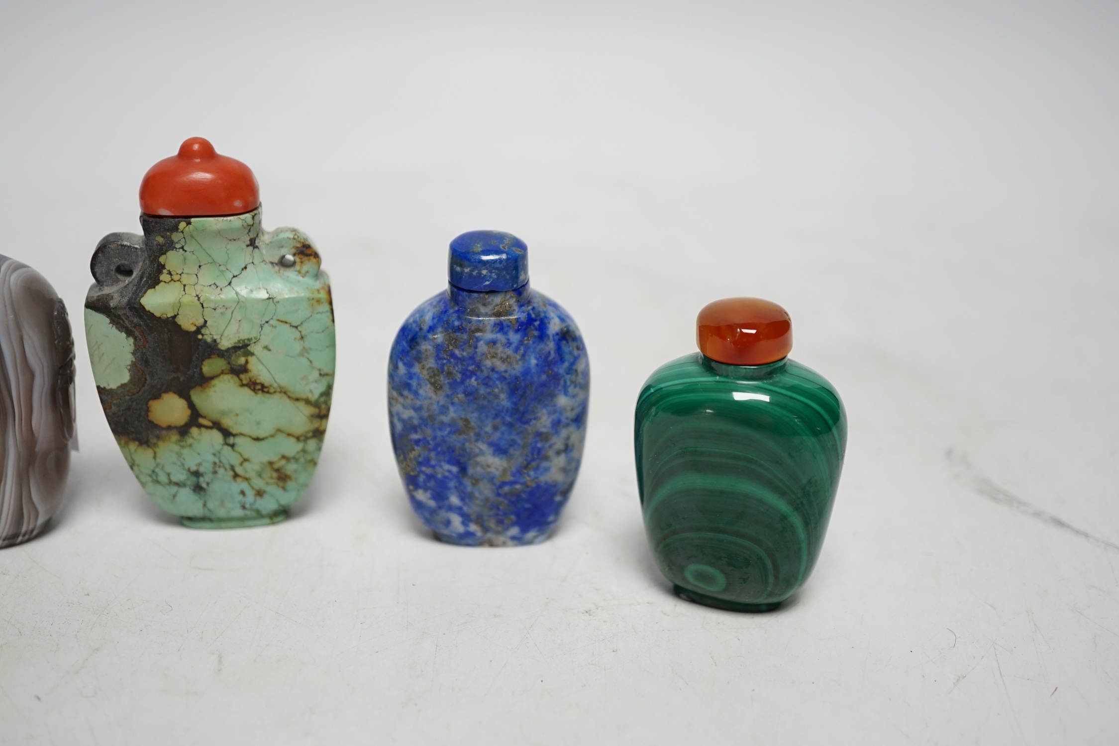 Five Chinese hardstone snuff bottles, 19th/20th century to include: black and grey marble, malachite, turquoise matrix, lapis lazuli and banded agate, largest 7.5cm high